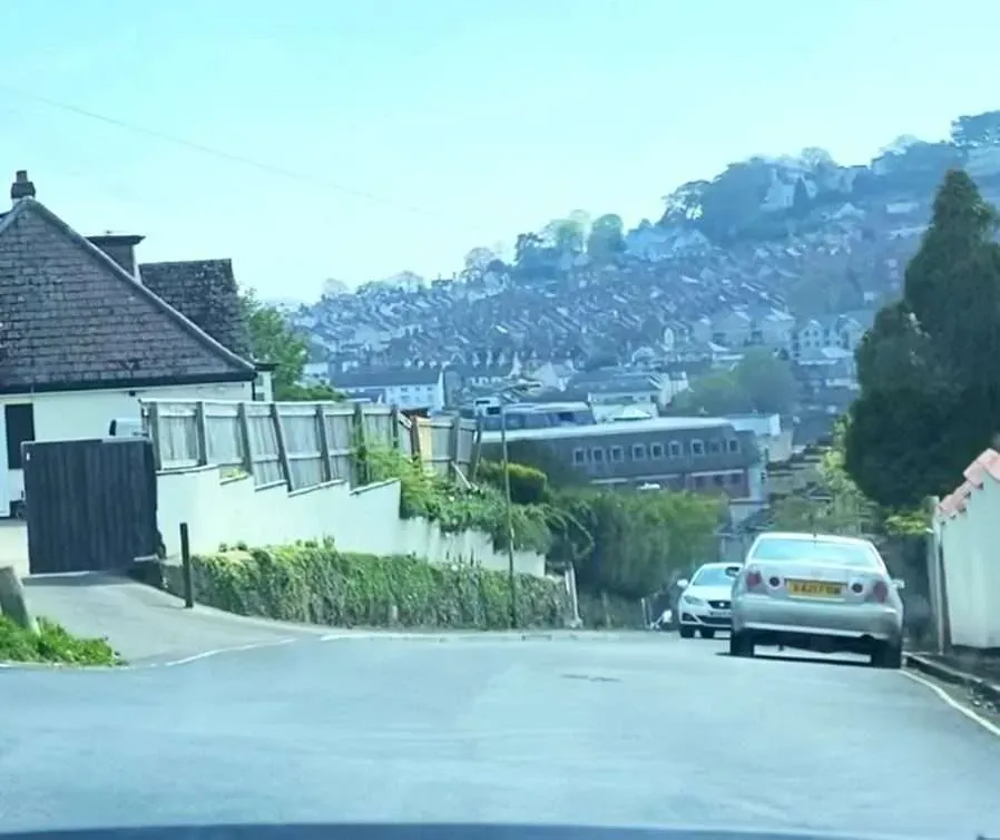 Positioned at the hold back point while giving way